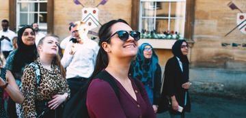 Equality, Equity, Diversity, & Inclusion - Group of students walking through college grounds